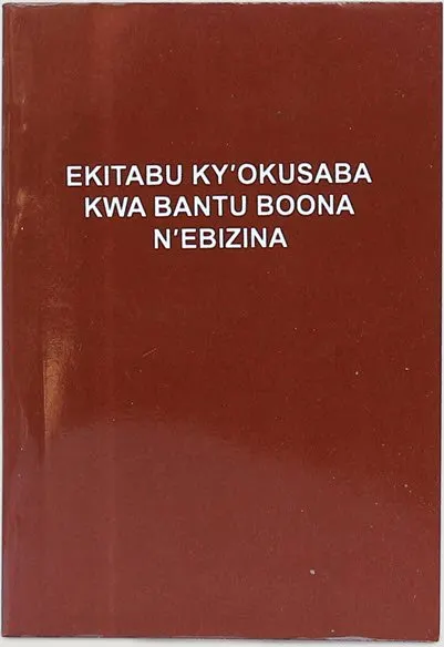 Maroon cover of Ekitabu ky'Okusaba kwa Bantu Boona n'Ebizina, the Runyoro-Rutooro prayer and hymn book